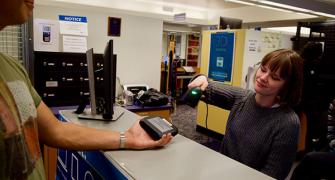 A student scans the bar code of a portable battery pack. 